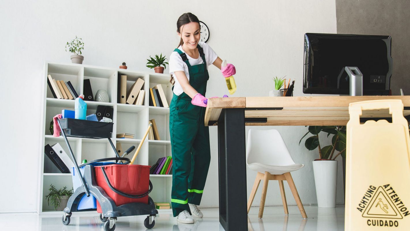 A Woman cleaning office table